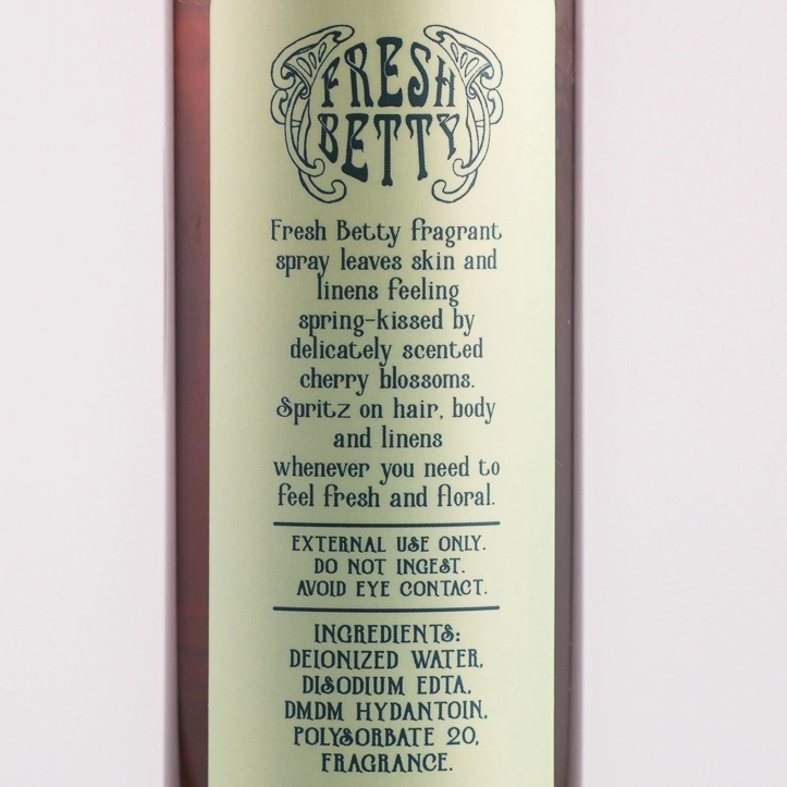 Brown spray bottle with green label on a white background