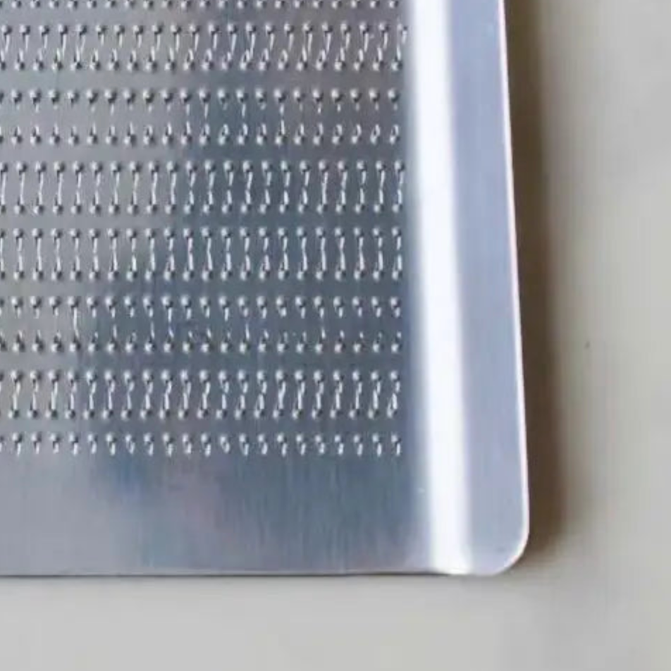 Metal grater on a light-colored surface