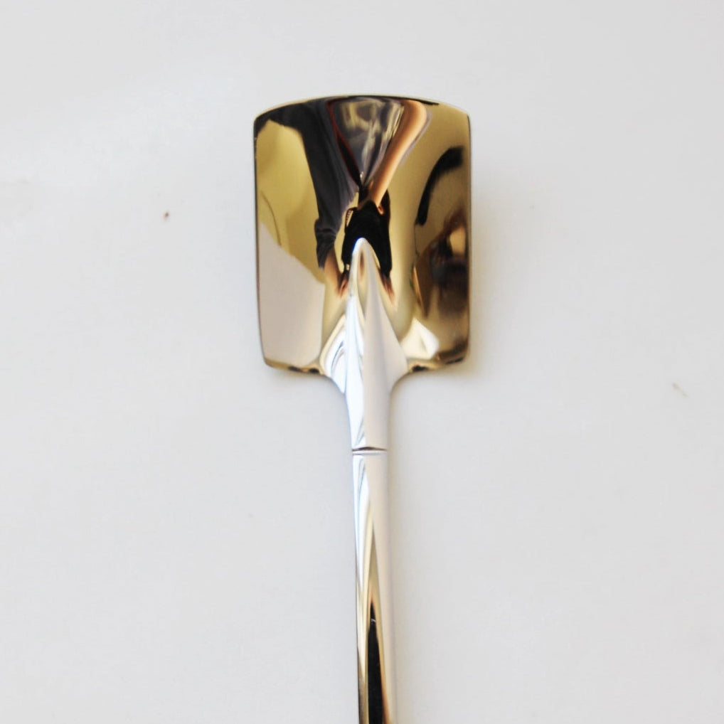 Gold-colored tool on a marble surface