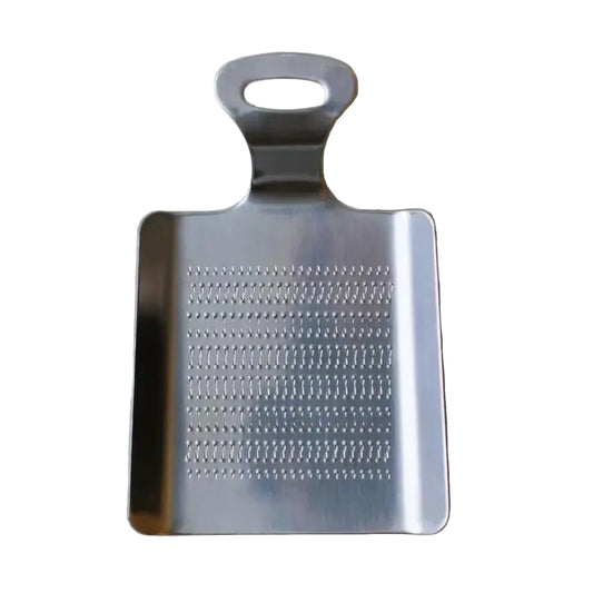 Metal grater on a light gray background