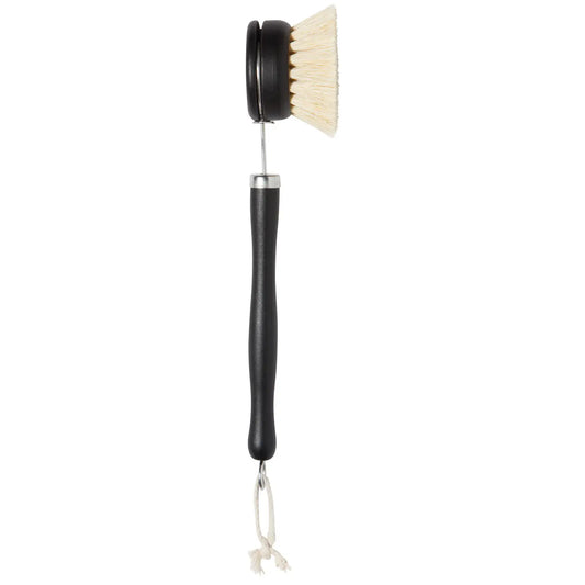 Cleaning brush with black handle and white bristles on a white background