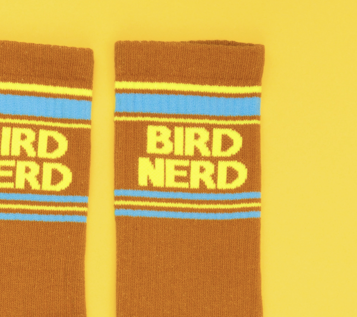 Brown socks with 'BIRD NERD' text on a yellow background