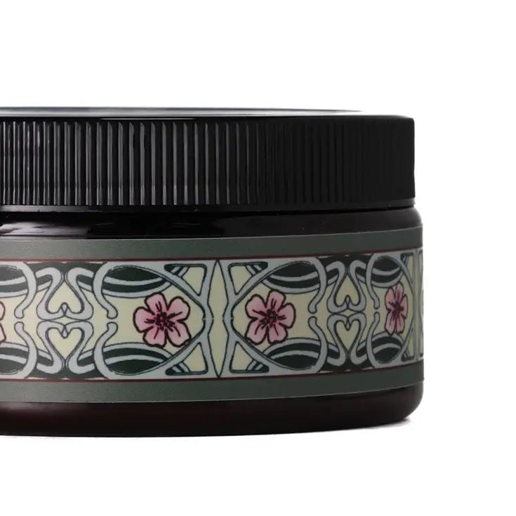 Jar with decorative label and black lid on a white background